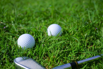 Golf ball and tee on golf green course background