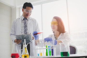 Scientists with test tubes and chemical test or laboratory research.Scientific concepts in...