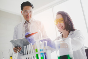 Scientists with test tubes and chemical test or laboratory research.Scientific concepts in...