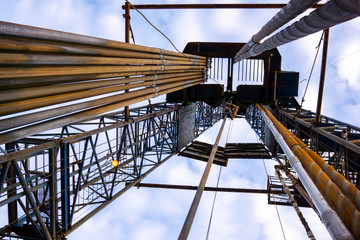 Oil and Gas Drilling Rig onshore dessert with dramatic cloudscape. Oil drilling rig operation on...