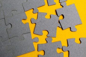 Obraz premium Texture puzzles gray on a yellow background