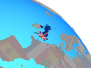United Kingdom with national flag on simple blue political globe.
