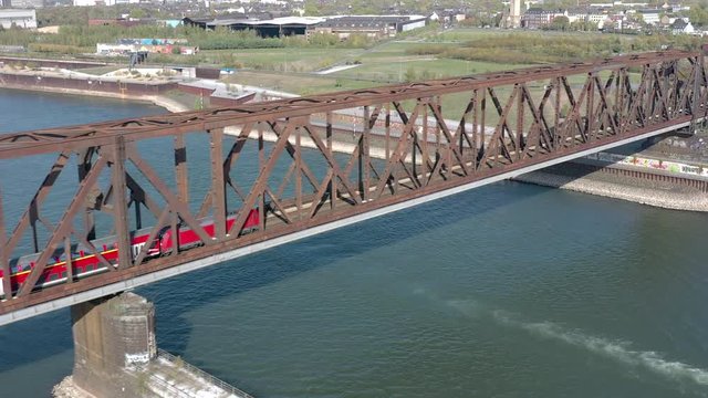 Commuter Train Crossing an Iron Bridge over a River