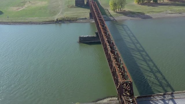Commuter Train Crossing an Iron Bridge over a River