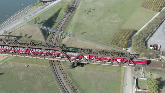 Commuter Train Crossing an Iron Bridge over a River