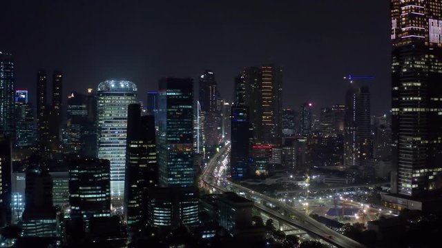 JAKARTA, Indonesia - October 23, 2018: Beautiful aerial Jakarta cityscape at nighttime with view of skyscrapers and highway. Shot in 4k resolution