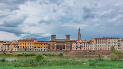 Fototapeta na wymiar Houses and Florence National Central Library over Arno River in Florence, Italy