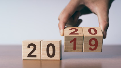 New year 2019 change to 2020 concept, hand change wooden cubes