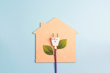 House symbol with plug like a plant on a blue  background. Save energy concept.
