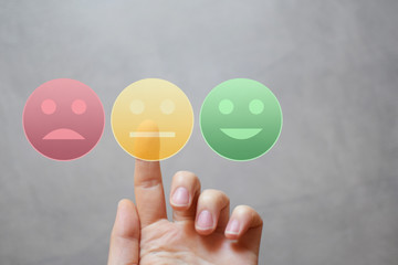 Finger rating with neutral happy sad face icons by pressing yellow button on virtual interface. Customer satisfaction service quality online evaluation and survey. Neutral feedback concept. - obrazy, fototapety, plakaty