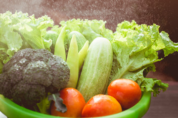 Healthy Food. There are vegetables, cucumbers, tomatoes and broccoli in the sieve for cleaning.