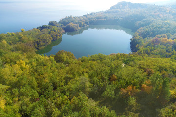 Picturesque mountain forest lake in autumn. Lake near the sea. Beautiful wild nature. Aerial view