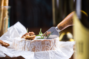 Camembert cheese cut by cheese knife