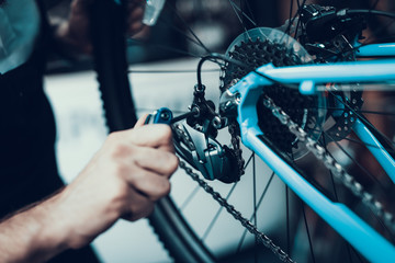 Mechanics Hand Repairing Bicycle in Bike Workshop