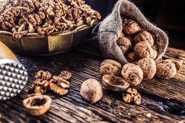 Walnut kernels whole walnuts in burlap sack and vintage bowl