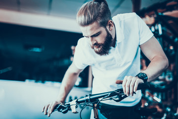 Obraz na płótnie Canvas Closeup of Man look at Cycle Details in Bike Shop