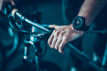 Closeup of Male Hand Holds Cycle Handlebar