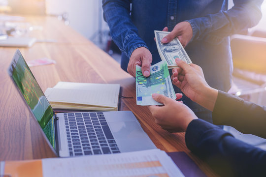 Exchange money, Business peoople exchange American dollars for Euro money