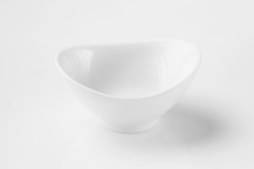 Closeup asymmetrical empty clean bowl isolated at white background.