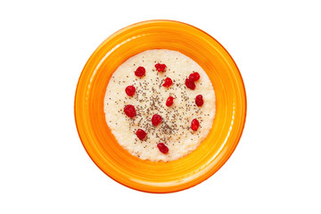 Top view orange bowl of semolina sweet porridge with chia seeds and dried berries isolated at white background. Concept of healthy lifestyle.