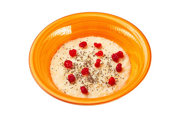 Top view orange bowl of semolina sweet porridge with chia seeds and dried berries isolated at white background. Concept of healthy lifestyle.