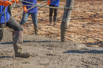 Pouring ready-mixed concrete from mixing mobile the concrete mixer from concrete pump and placing...