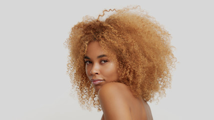 mixed race black blonde model with curly hair - obrazy, fototapety, plakaty