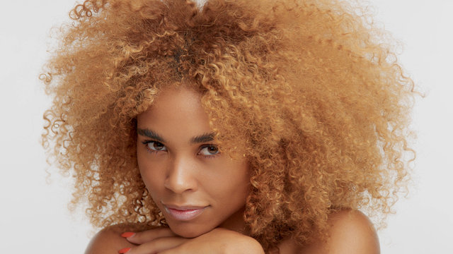 mixed race black blonde model with curly hair. Big afro blonde hair