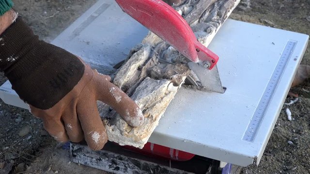Construction worker cutting stone slabs, close up