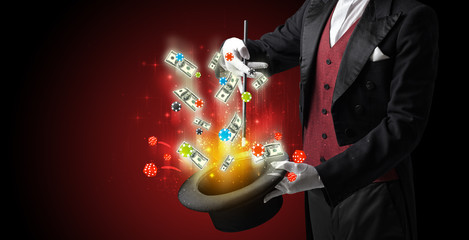 Illusionist conjure with magic wand gambling things from a cylinder