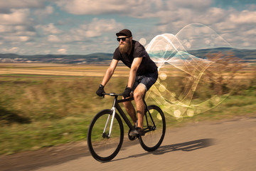 Fototapeta na wymiar Gorgeous biker in the nature going somewhere with ethereal concept