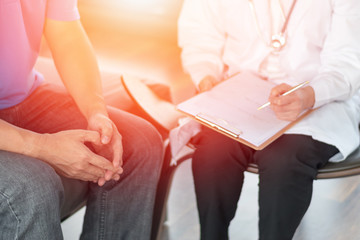 Doctor physician consulting with male patients in hospital exam room. Men's health concept. Psychologist consult in psychotherapy session. - obrazy, fototapety, plakaty