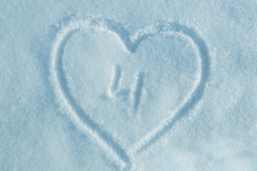 A figure of four written in the snow in the painted heart. Snow texture.