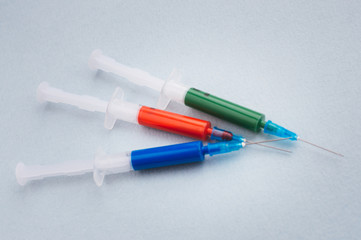Three syringes on a light background. Vaccine concept.