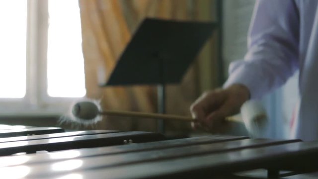 Musician playing on xylophone sticks