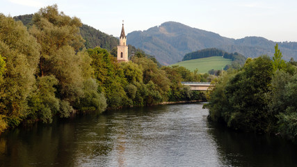 Fototapeta premium View of Mur river with church in Leoben,Austria