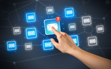 Female hand touching unread mail icon with more envelope icons around it 