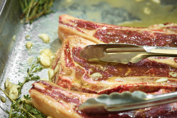 Raw fresh meat T-bone steak on grill iron pan