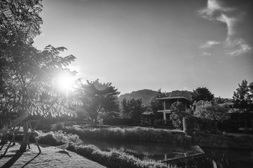 View of the village and lake, while the sun falls on the evening of the day. Black and white concept