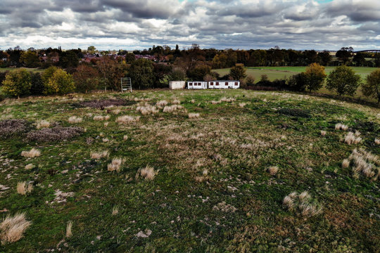 Abandoned Cricket Field With Boarded Up Clubhouse