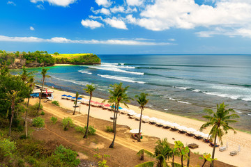 Azure beach with rocky mountains and clear water of Indian ocean at sunny day / A view of a cliff in Bali Indonesia / Bali, Indonesia