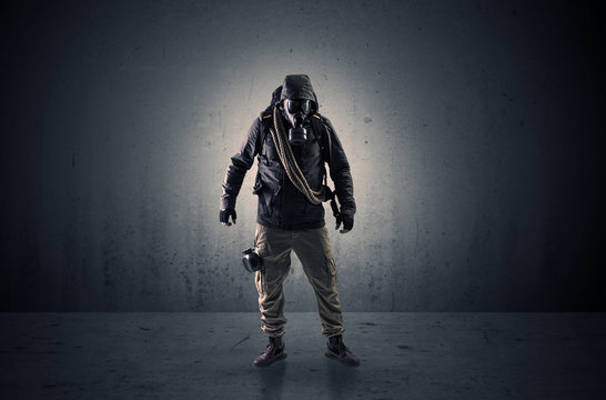 Bad agent in a dark room with arms on his hand and gas mask
