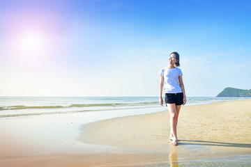 Beautiful women walking on the beach see blue sky and sea on background