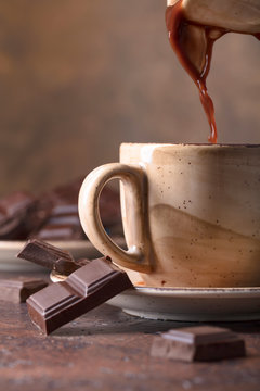 Cup of hot chocolate and bitter chocolate pieces.