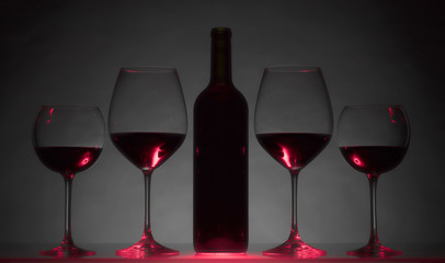 Glasses and bottle of red wine.