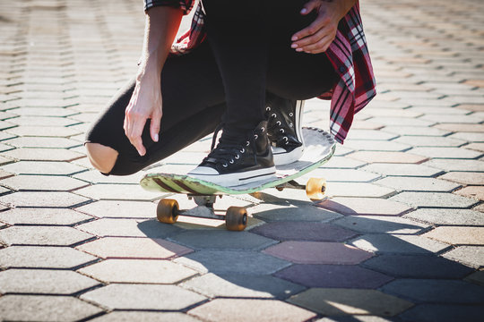 Beautiful woman with a skateboard on the street