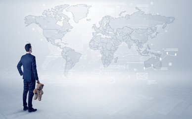 Businessman standing with his back and looking at a worldwide map with objects in his hand
