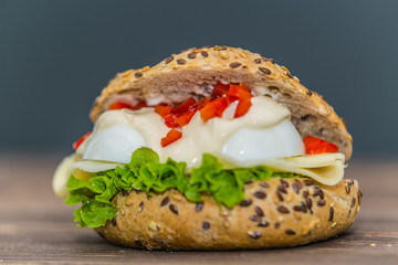 Fresh baguette sandwich on wooden background. Classic BLT sandwiches. Close up.