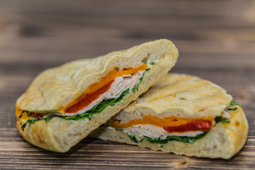 Fresh baguette sandwich on wooden background. Classic BLT sandwiches. Close up.