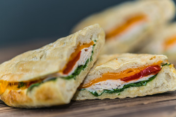Fresh baguette sandwich on wooden background. Classic BLT sandwiches. Close up.